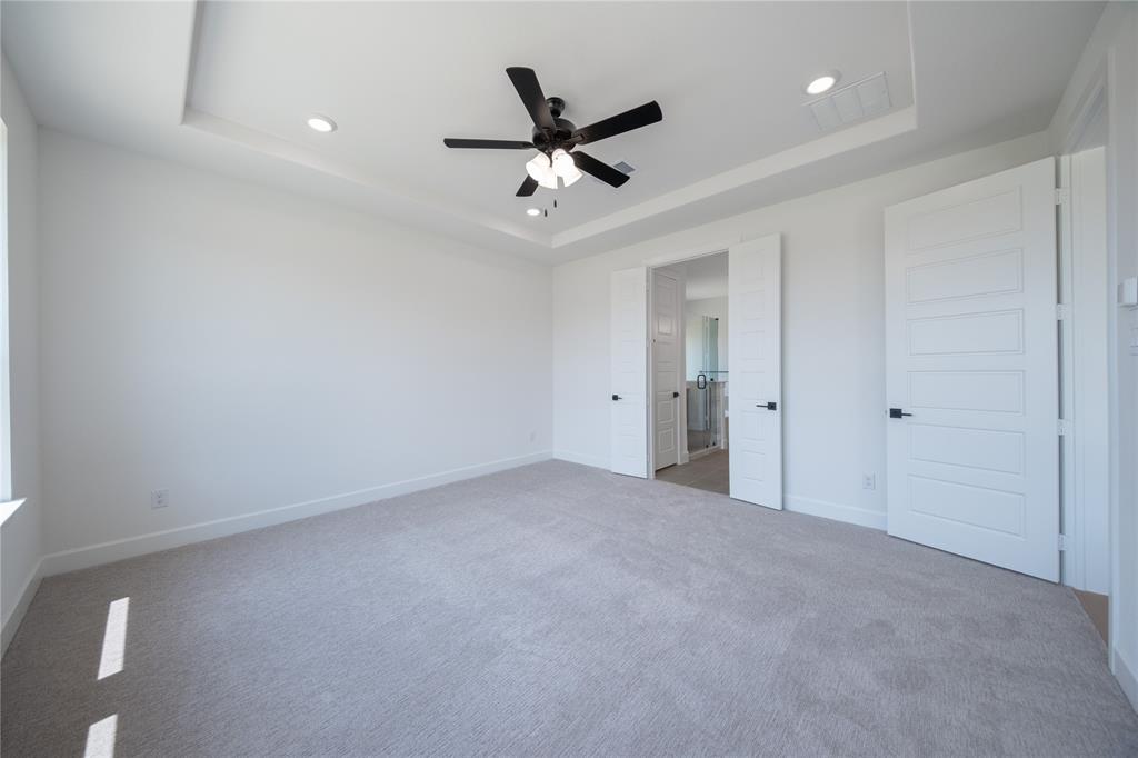 2719 Triumph Court Heath, TX 75126 - Photo 27 of 39 an empty room with ceiling fan and window
