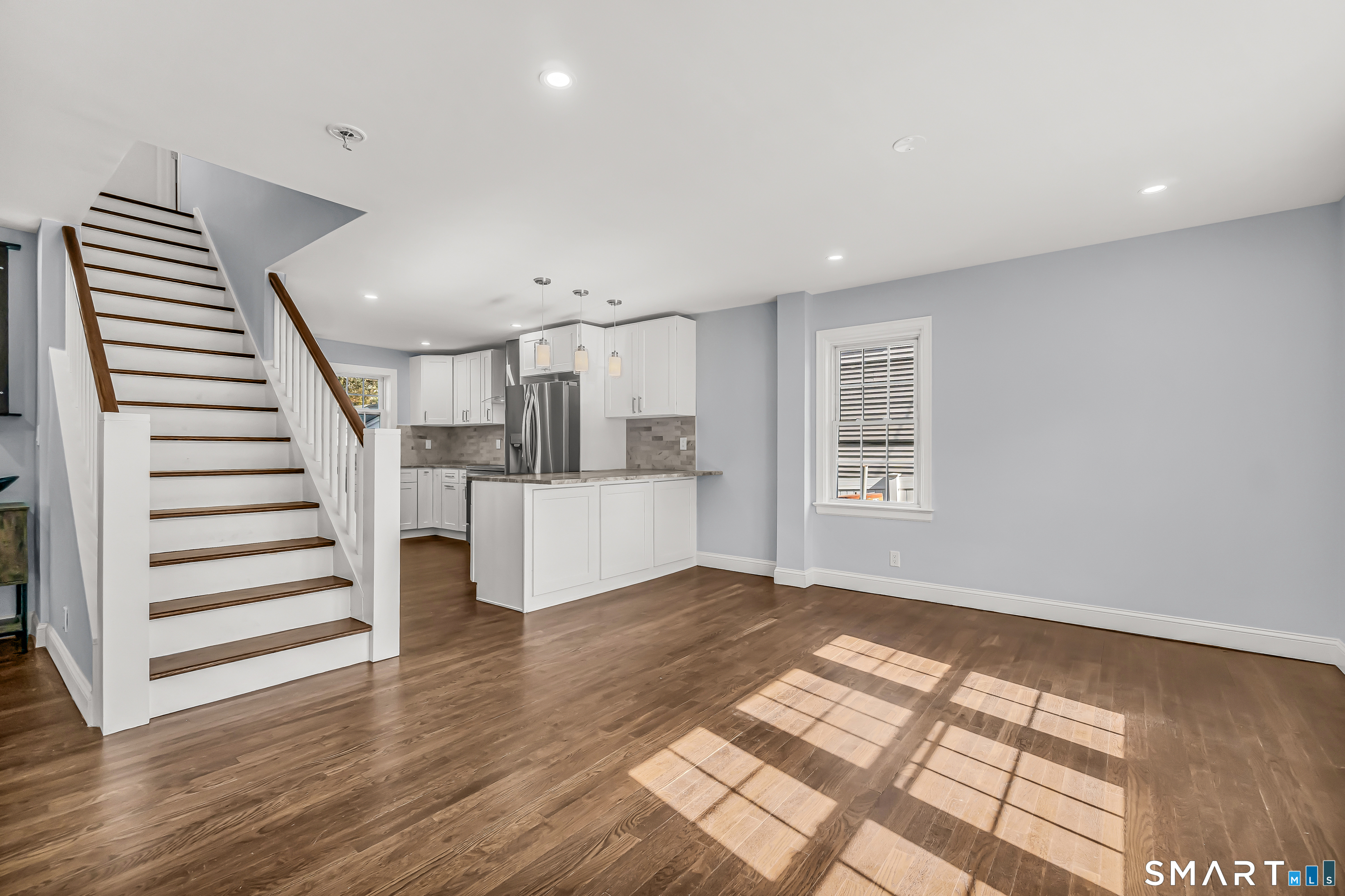 1770 Stratfield Road Fairfield, CT 06825 - Photo 6 of 40 a view of entryway with wooden floor and stairs