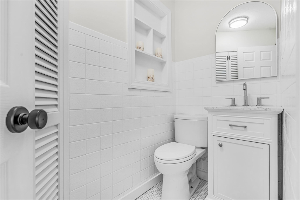 4 Retrop Road Natick, MA 01760 - Photo 13 of 26 a bathroom with a toilet a sink and mirror