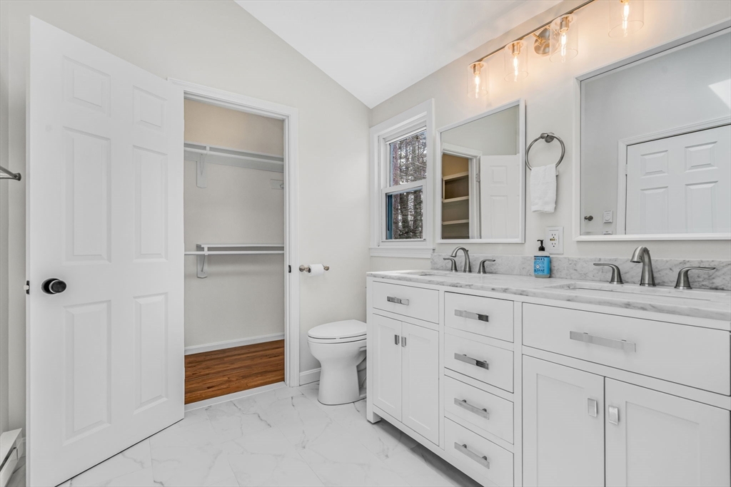 4 Retrop Road Natick, MA 01760 - Photo 15 of 26 a spacious bathroom with a double vanity sink a mirror and a toilet