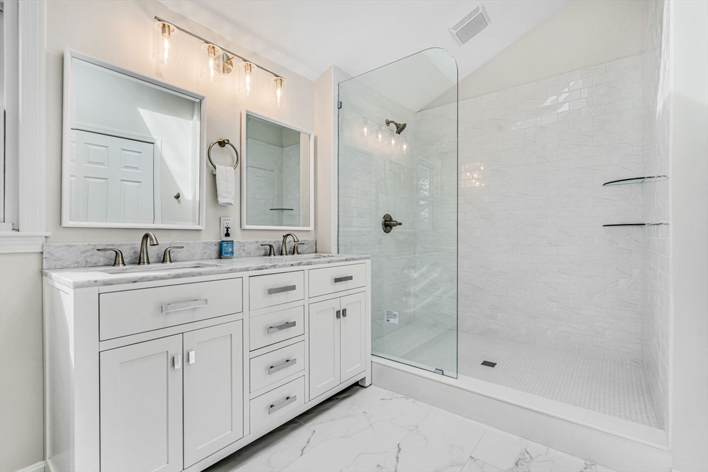 4 Retrop Road Natick, MA 01760 - Photo 16 of 26 a bathroom with a shower sink vanity and mirror