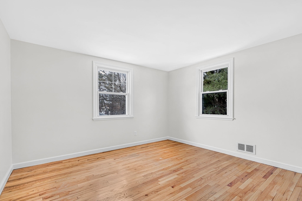 4 Retrop Road Natick, MA 01760 - Photo 21 of 26 a view of an empty room with wooden floor and a window