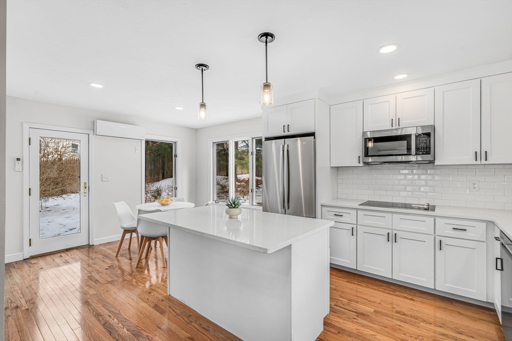 4 Retrop Road Natick, MA 01760 - Photo 8 of 26 a large kitchen with kitchen island a sink white cabinets and stainless steel appliances