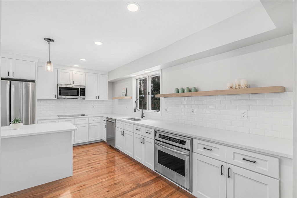 4 Retrop Road Natick, MA 01760 - Photo 9 of 26 a large kitchen with stainless steel appliances granite countertop a stove and a sink
