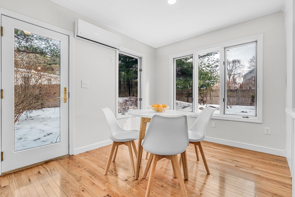 4 Retrop Road Natick, MA 01760 - Photo 10 of 26 a dining room with wooden floor a glass table and chairs