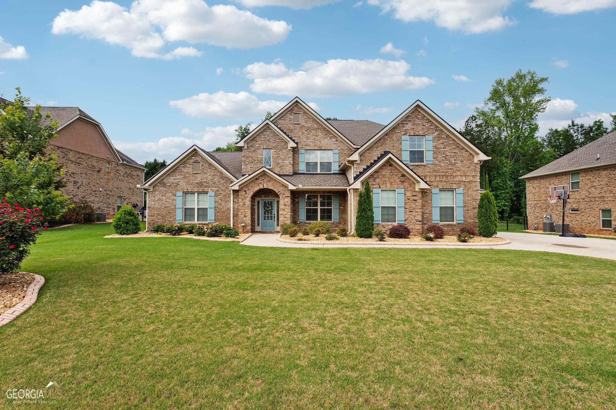1872 Schofield Drive Hampton, GA 30228 - Photo 1 of 1 a view of a white house with a small yard and a large tree