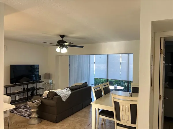 a bed sitting in a bedroom next to a window and chair