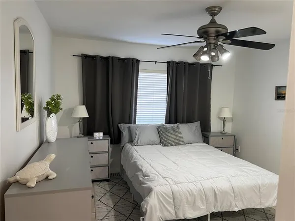 a bedroom with a bed and a chandelier