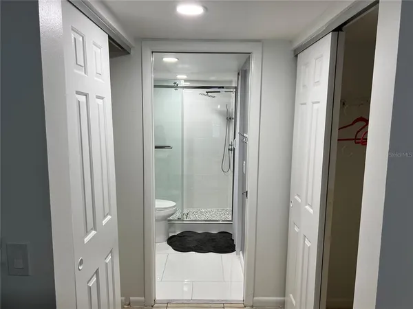 a bathroom with a shower toilet and sink