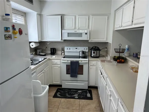 a kitchen with stainless steel appliances granite countertop a sink a stove and dishwasher