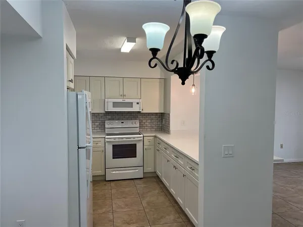 a kitchen with stainless steel appliances a refrigerator sink and cabinets