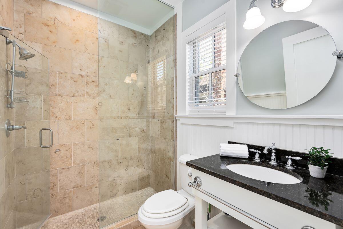 220 Salt Lane Watersound, FL 32461 - Photo 21 of 35 a bathroom with a granite countertop sink a toilet a mirror and shower