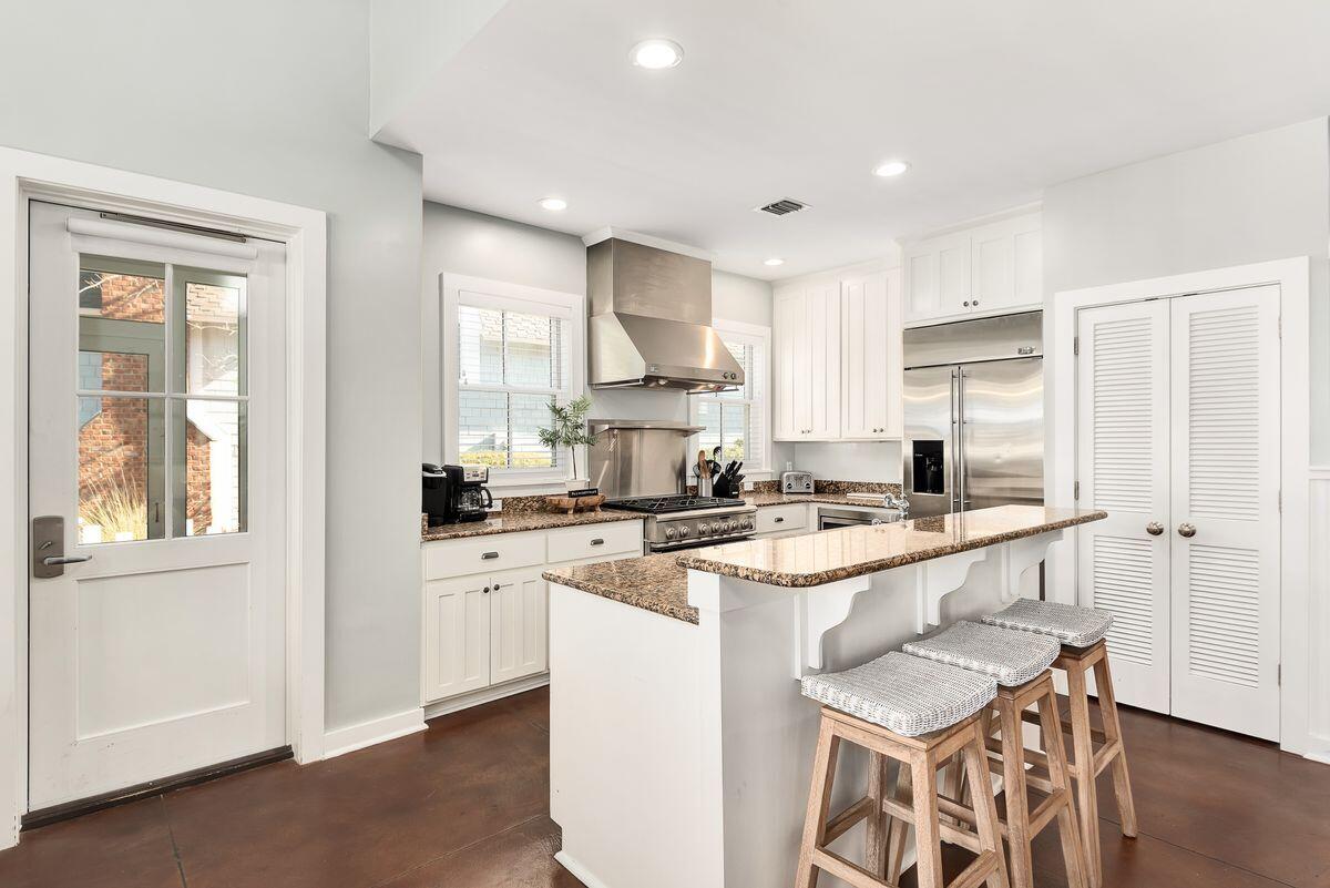 220 Salt Lane Watersound, FL 32461 - Photo 5 of 35 a kitchen with a sink stove cabinets and wooden floor