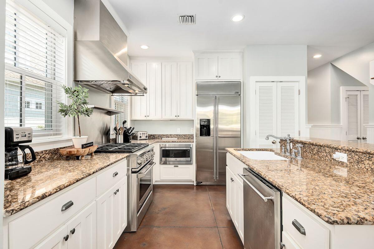 220 Salt Lane Watersound, FL 32461 - Photo 6 of 35 a kitchen with a sink stove and cabinets