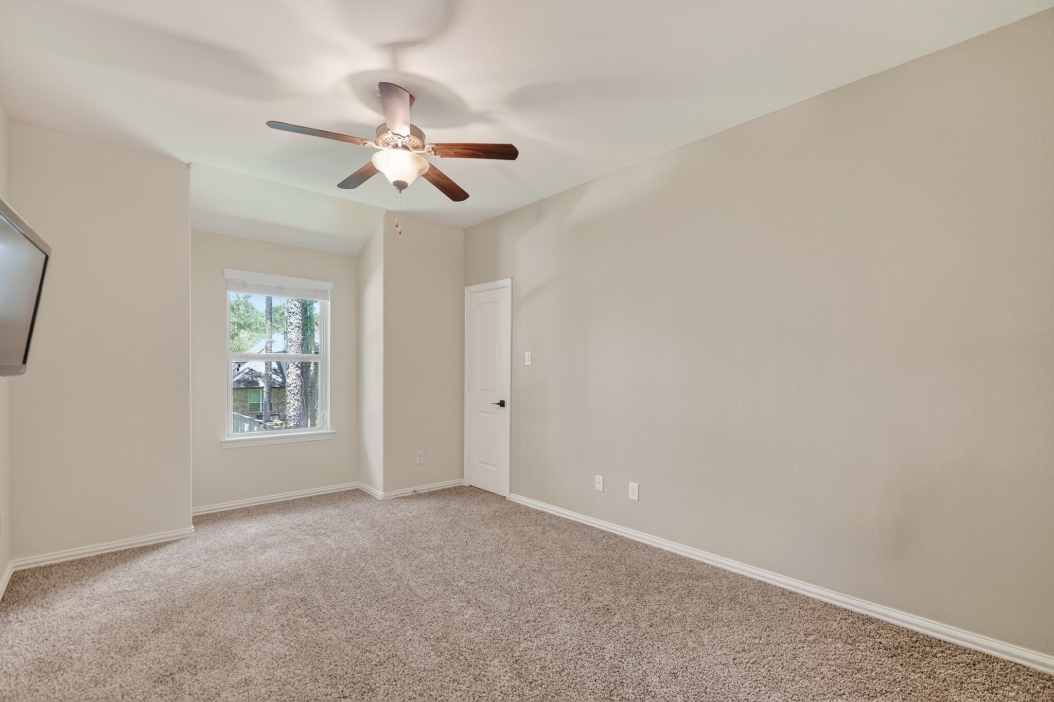 79 West Jagged Ridge Circle Spring, TX 77389 - Photo 37 of 50 This light-filled secondary bedroom offers plush carpet, neutral walls, and a window overlooking the front yard, providing a blank canvas ready for your personal style. Its comfortable size makes it ideal as a bedroom, nursery, or home office.
