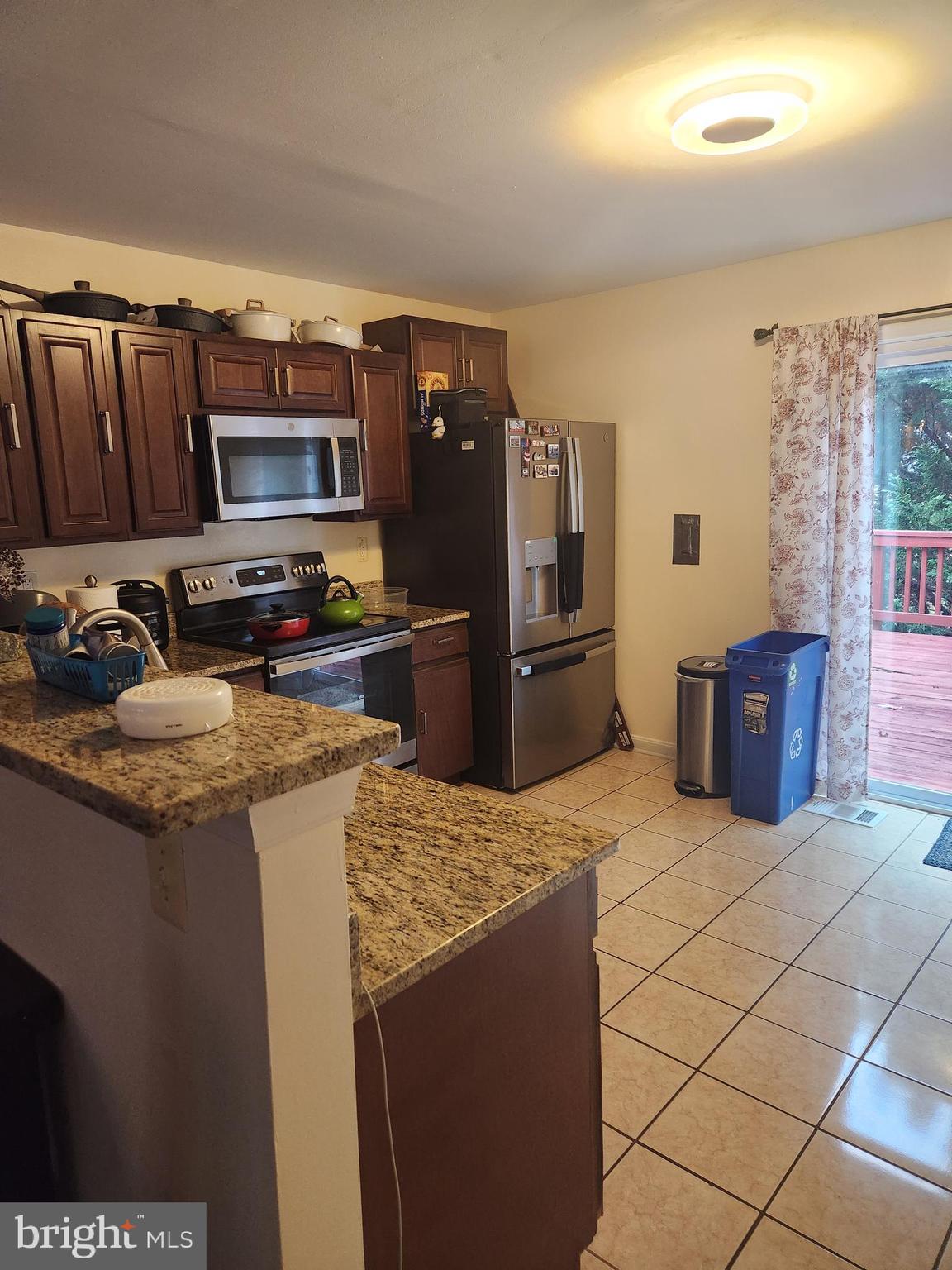 12912 Boggy Trail Way, Unit 55 Germantown, MD 20876 - Photo 12 of 27 a kitchen with stainless steel appliances granite countertop a refrigerator stove and sink