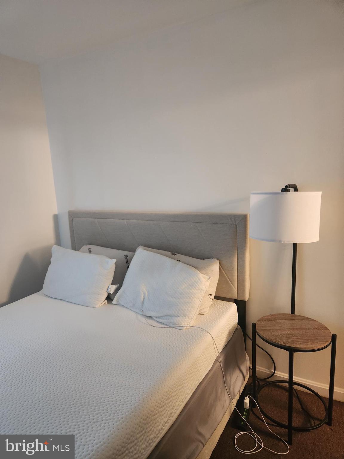 12912 Boggy Trail Way, Unit 55 Germantown, MD 20876 - Photo 20 of 27 a bedroom with a bed a lamp and a table