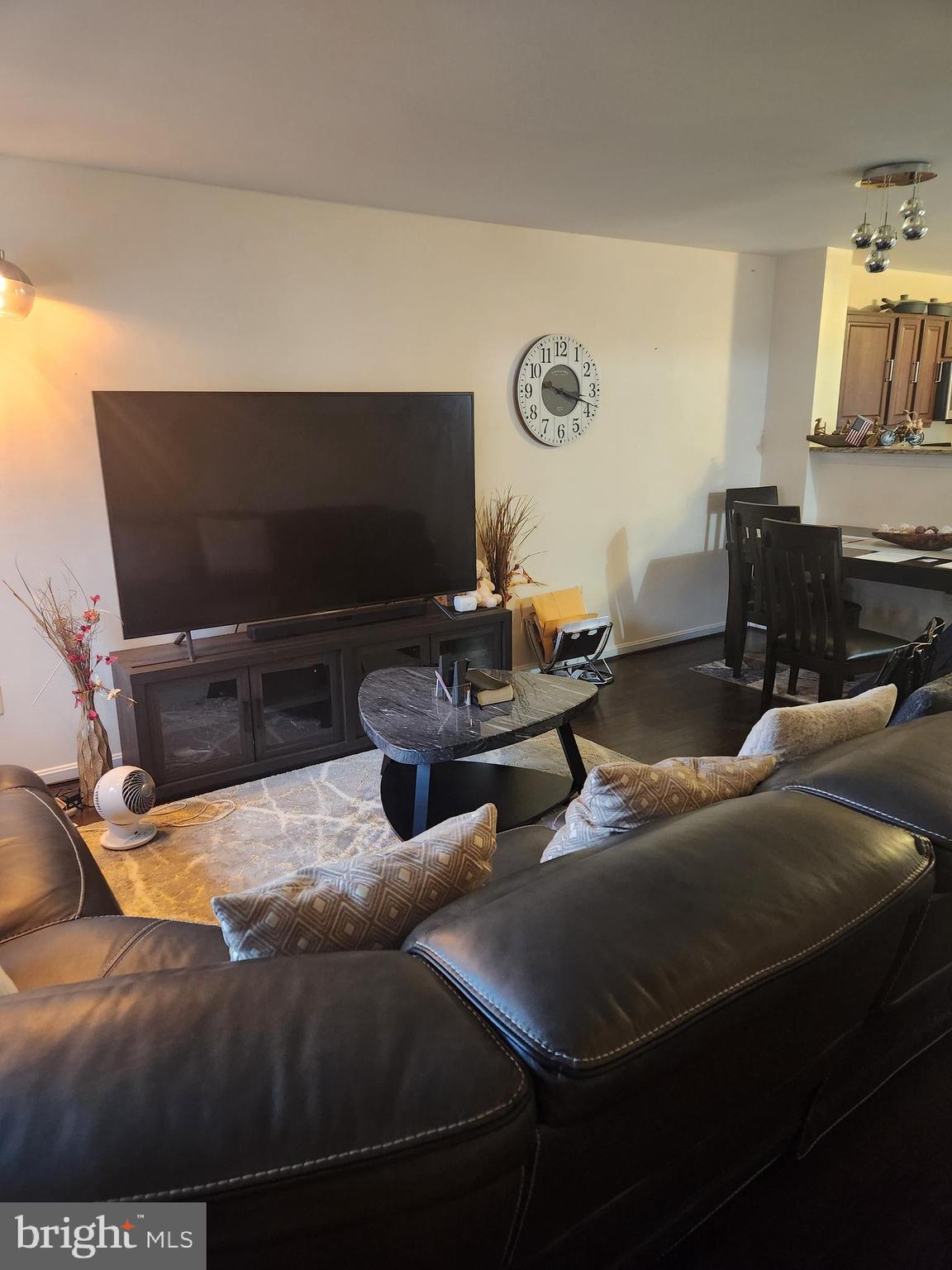 12912 Boggy Trail Way, Unit 55 Germantown, MD 20876 - Photo 7 of 27 a living room with furniture and a flat screen tv