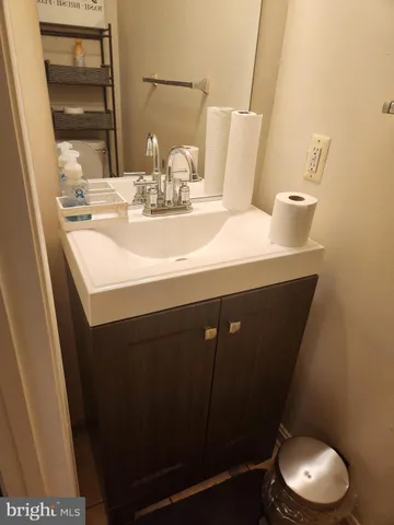 a bathroom with a sink a toilet and a mirror