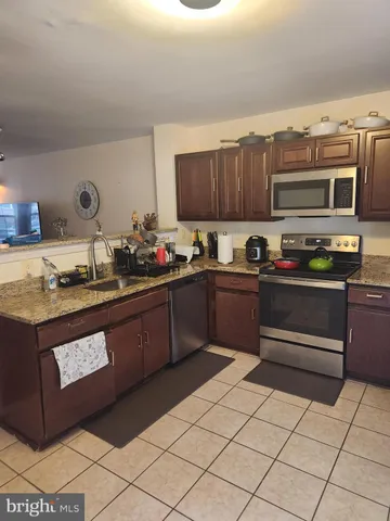 a kitchen with stainless steel appliances granite countertop a sink and cabinets