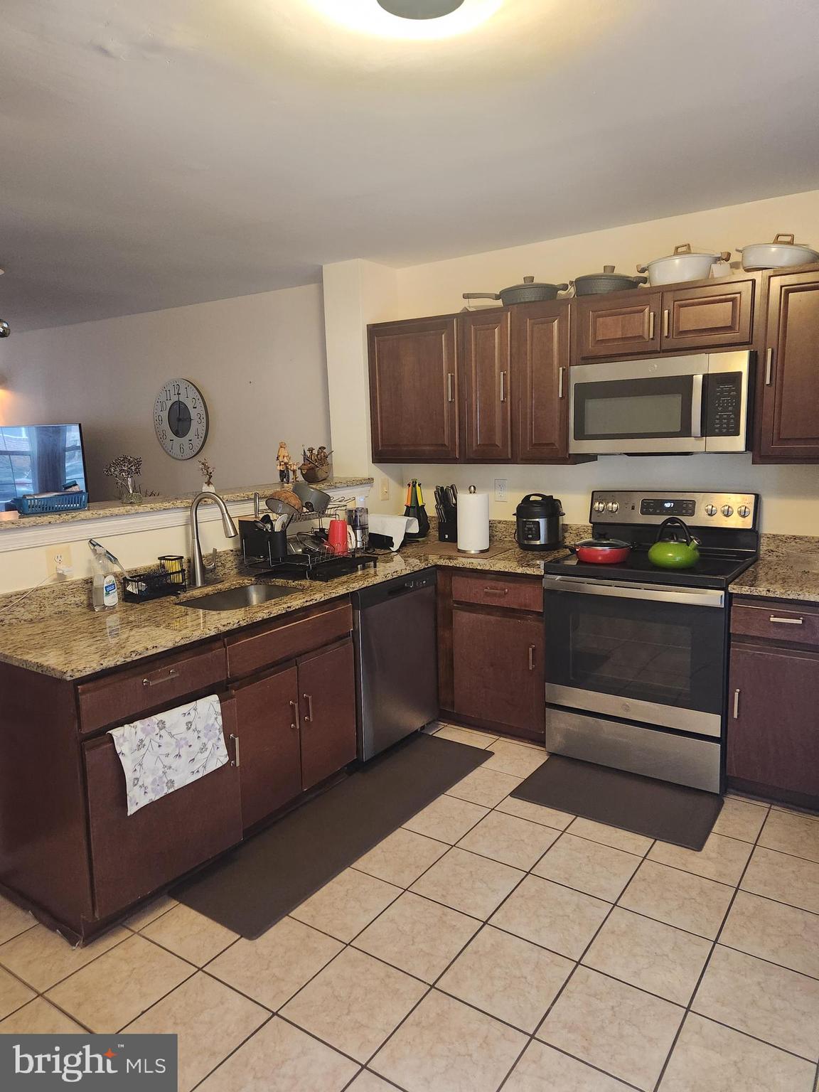 12912 Boggy Trail Way, Unit 55 Germantown, MD 20876 - Photo 10 of 27 a kitchen with stainless steel appliances granite countertop a sink and cabinets