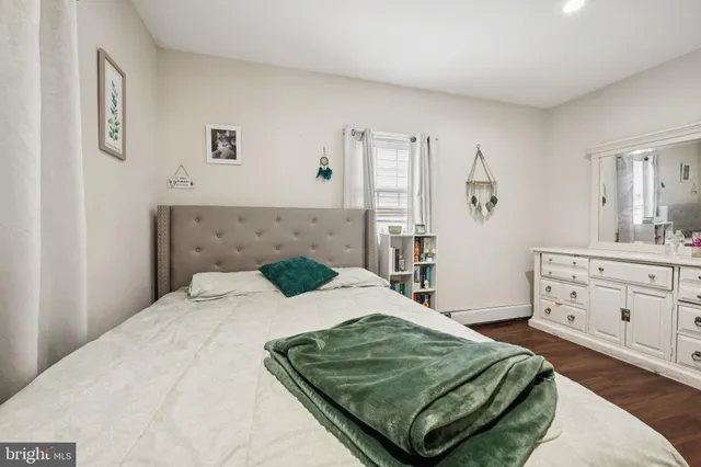 a bed sitting in a bedroom and dresser