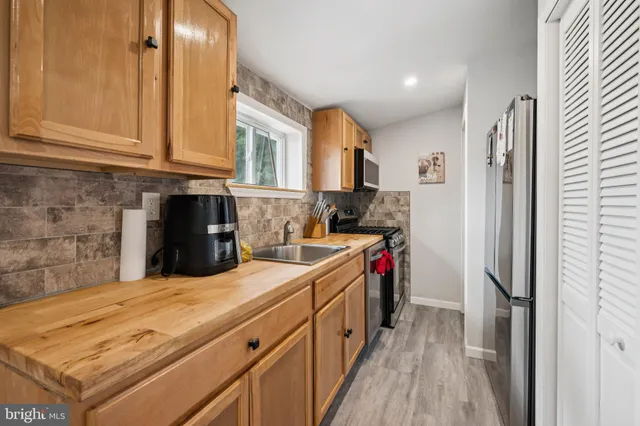 a kitchen with a refrigerator and a sink