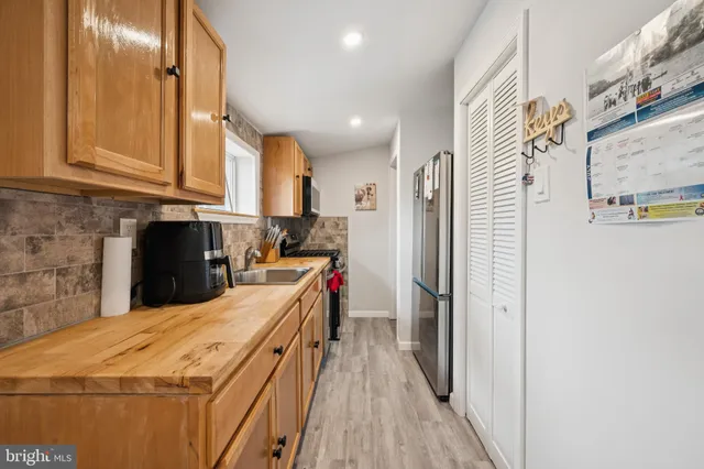 a kitchen with stainless steel appliances a refrigerator and a stove