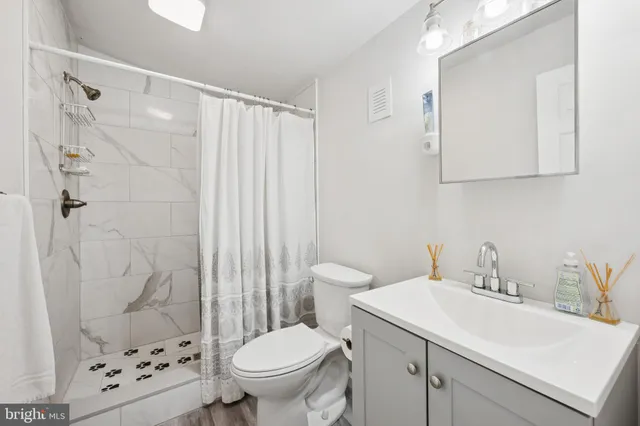 a bathroom with a sink toilet and shower
