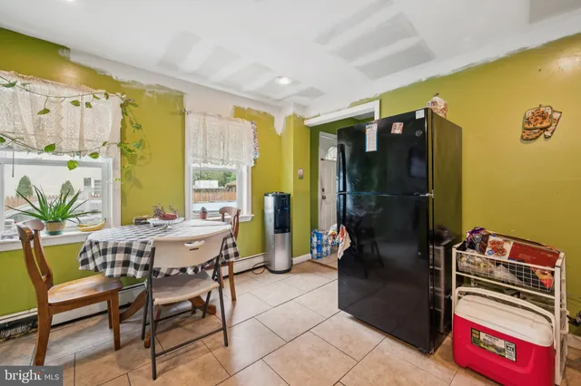 a view of a dining room with furniture and a window