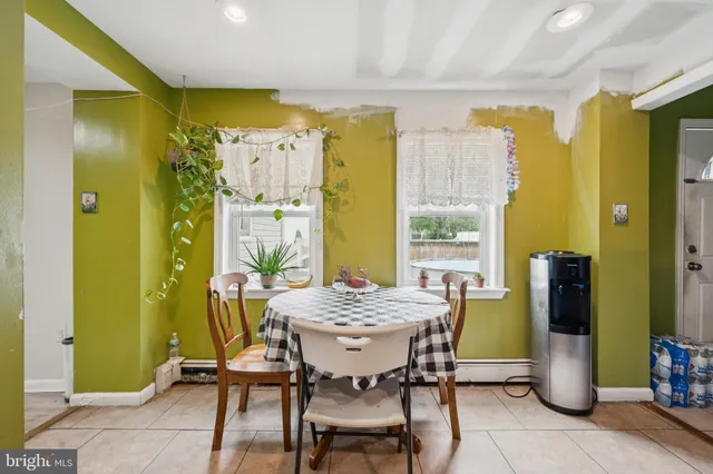 a view of a dining room with furniture and a window