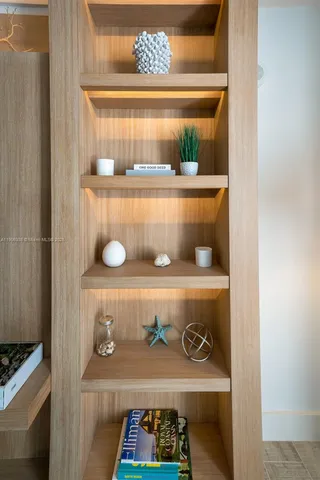a view of a hallway with wooden floor and a potted plant