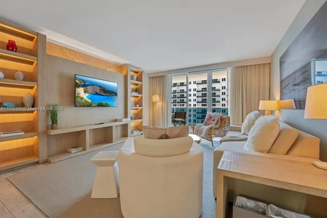 a living room with furniture and a floor to ceiling window