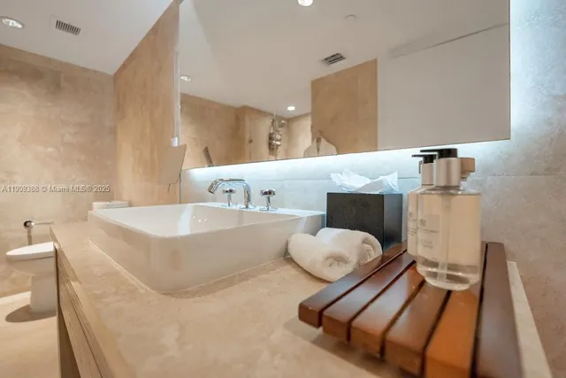 a bathroom with a tub sink and a mirror