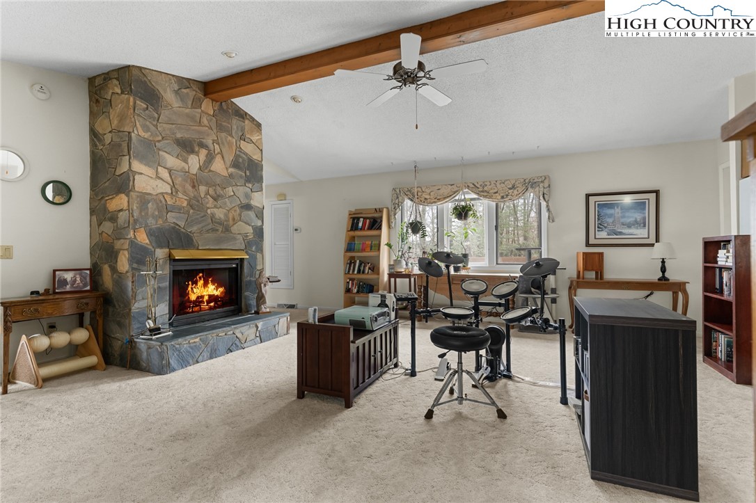 120 Village Road Glade Valley, NC 28627 - Photo 11 of 30 a view of a livingroom with furniture and a fireplace