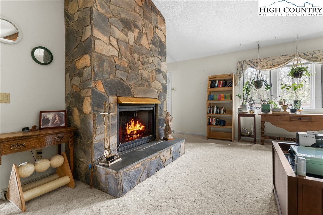 120 Village Road Glade Valley, NC 28627 - Photo 12 of 30 a living room with furniture and a fireplace
