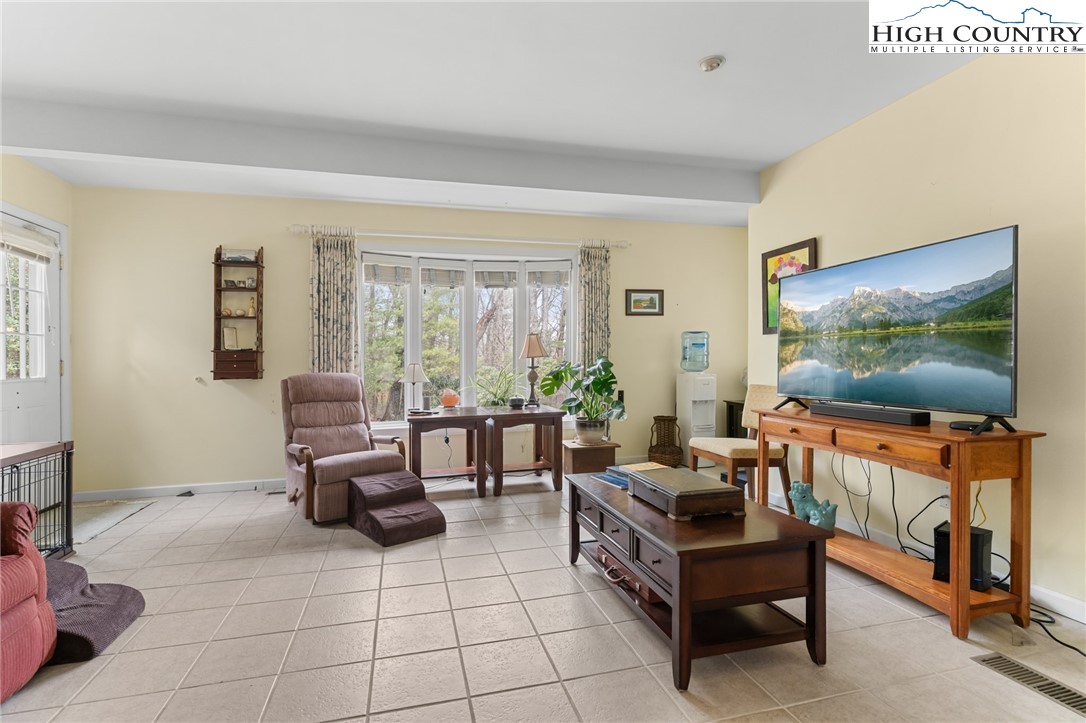 120 Village Road Glade Valley, NC 28627 - Photo 15 of 30 a living room with furniture and a flat screen tv