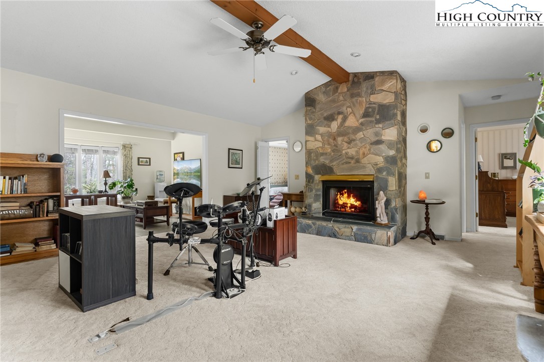 120 Village Road Glade Valley, NC 28627 - Photo 17 of 30 a living room with furniture a fireplace and a flat screen tv