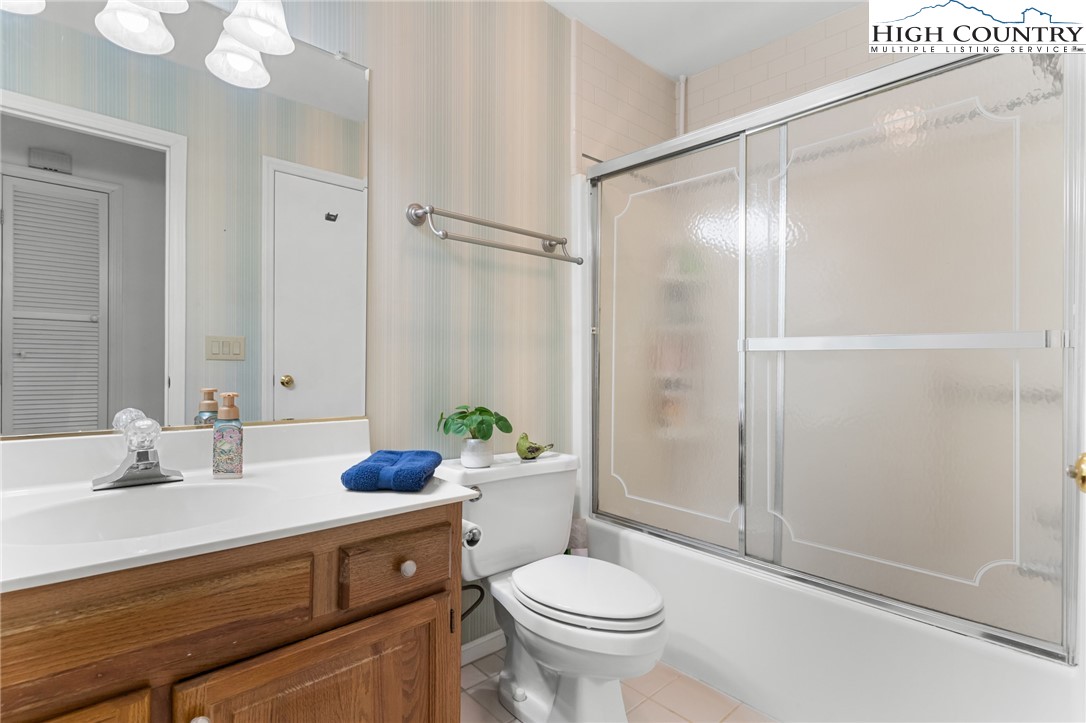 120 Village Road Glade Valley, NC 28627 - Photo 20 of 30 a bathroom with a sink toilet and shower