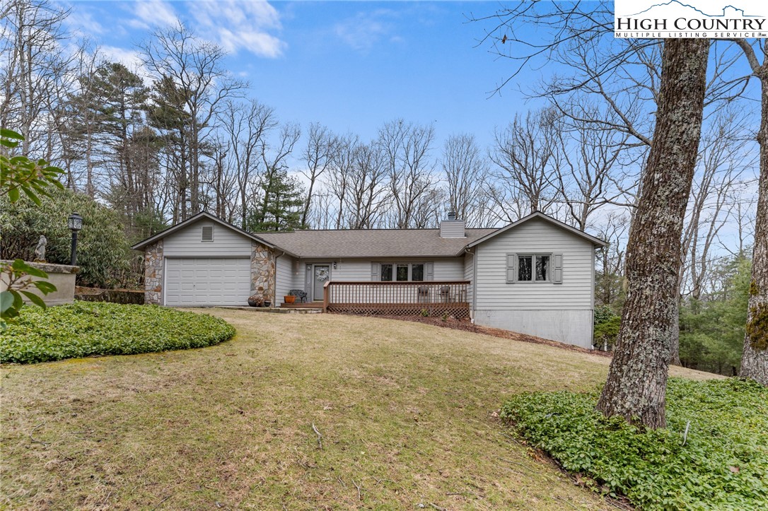 120 Village Road Glade Valley, NC 28627 - Photo 2 of 30 a front view of a house with a yard and garage