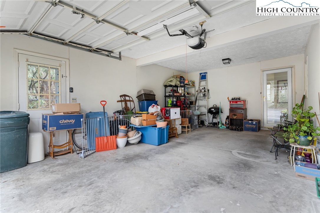 120 Village Road Glade Valley, NC 28627 - Photo 23 of 30 a view of a room with lots of furniture and a chandelier