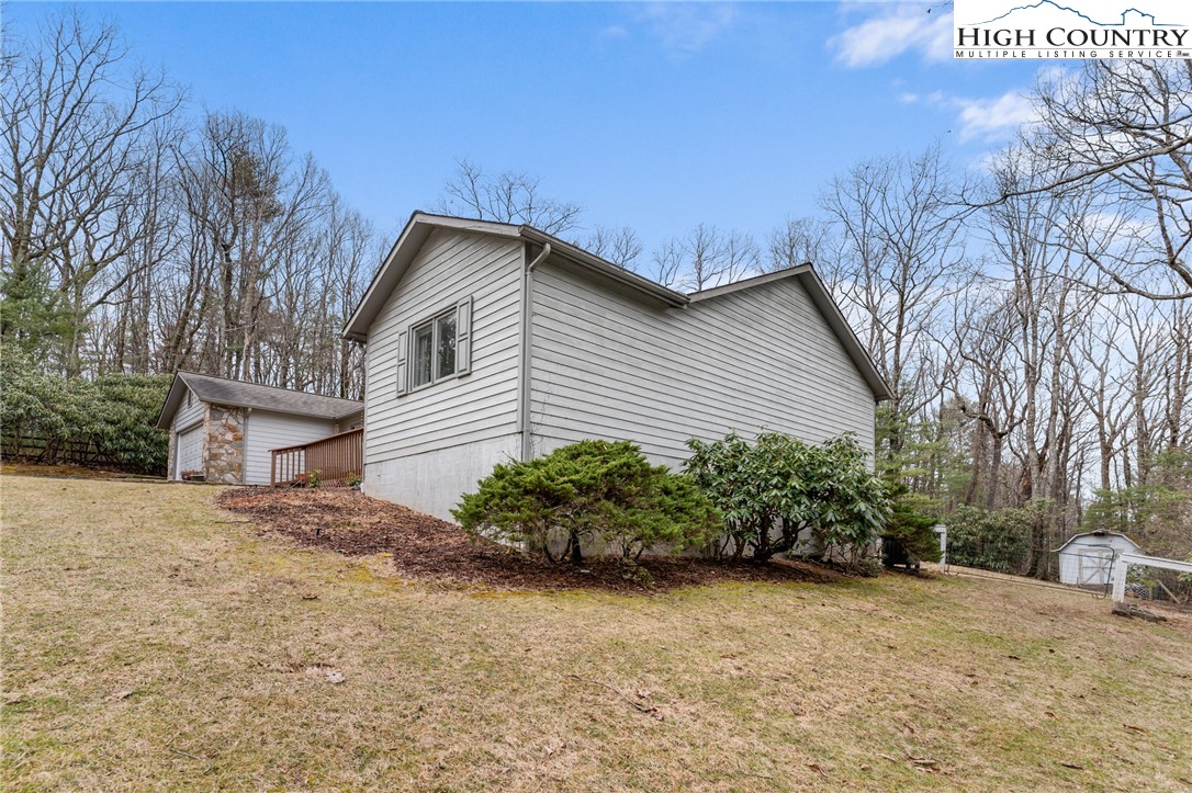 120 Village Road Glade Valley, NC 28627 - Photo 25 of 30 a front view of a house with a yard and potted plants