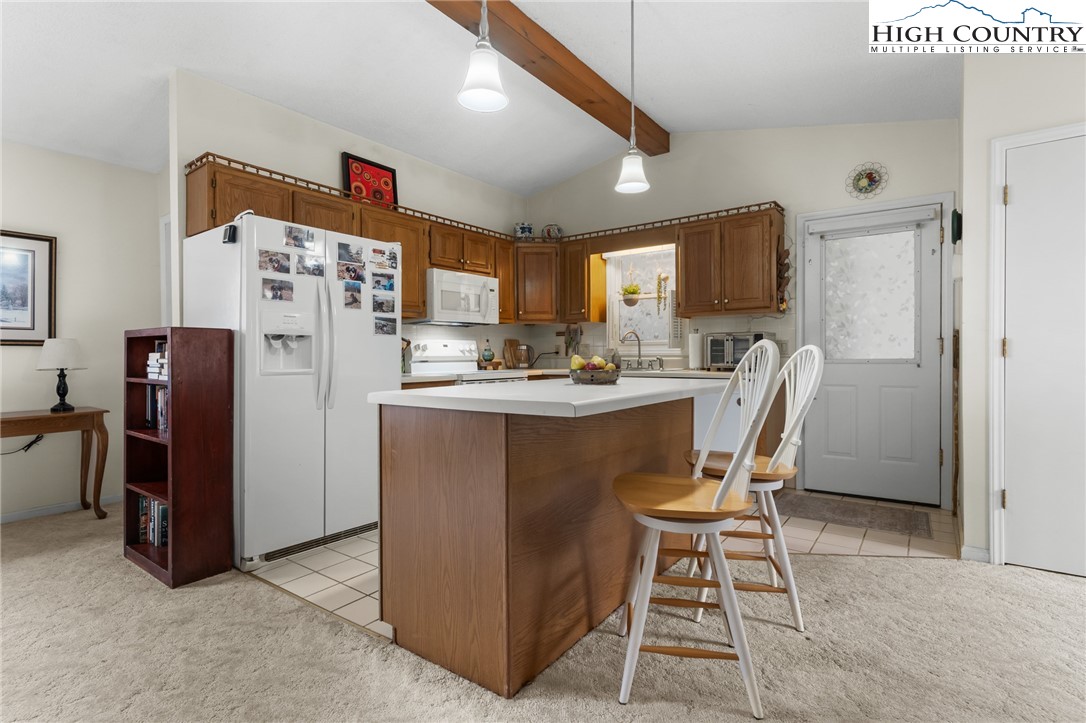 120 Village Road Glade Valley, NC 28627 - Photo 10 of 30 a dining room with stainless steel appliances a refrigerator and a refrigerator