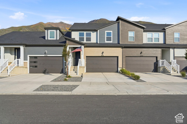 4751 Heartwood Road Mapleton, UT 84664 - Photo 1 of 33 Contemporary townhome exterior featuring multi-toned siding, attached garages, and a paved driveway
