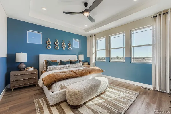 a bedroom with a bed and a painting on the wall