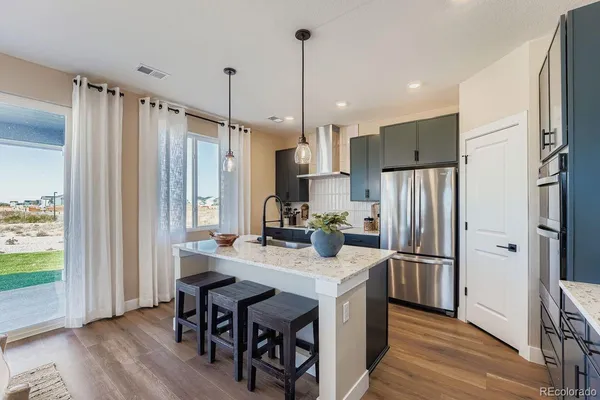 a kitchen with stainless steel appliances kitchen island a large island in the center