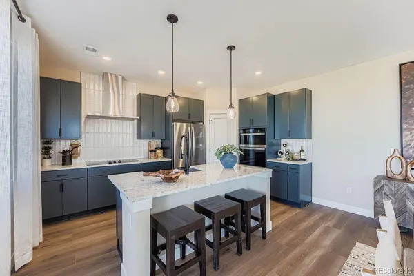 a kitchen with a sink a counter and chairs