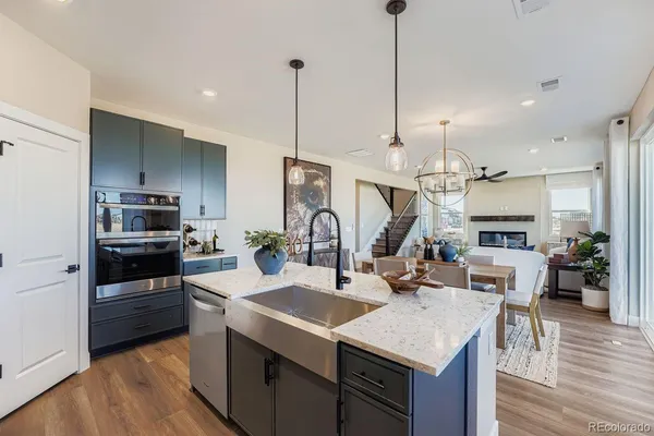 a kitchen with a table chairs and flat screen tv