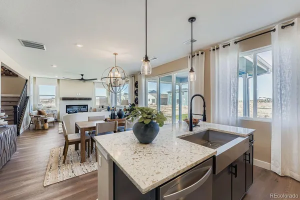 a view of a dining room with furniture a chandelier and wooden floor