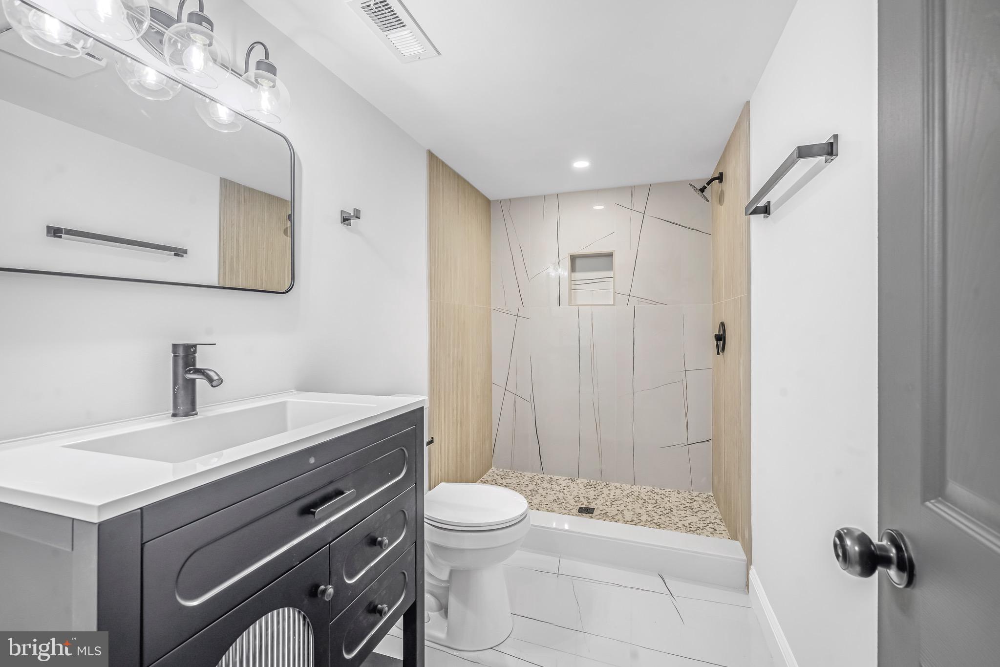 840 Benninghaus Road Baltimore, MD 21212 - Photo 23 of 30 a bathroom with a sink a toilet and shower